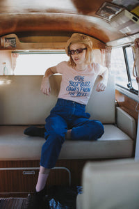 Woman sat in campervan wearing Peach The Best Buzz Comes from the Bees Shirt by The Bee and The Fox