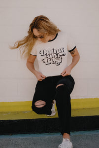 Woman leaning on a wall wearing Doing My Best Ringer Tee by The Bee and The Fox